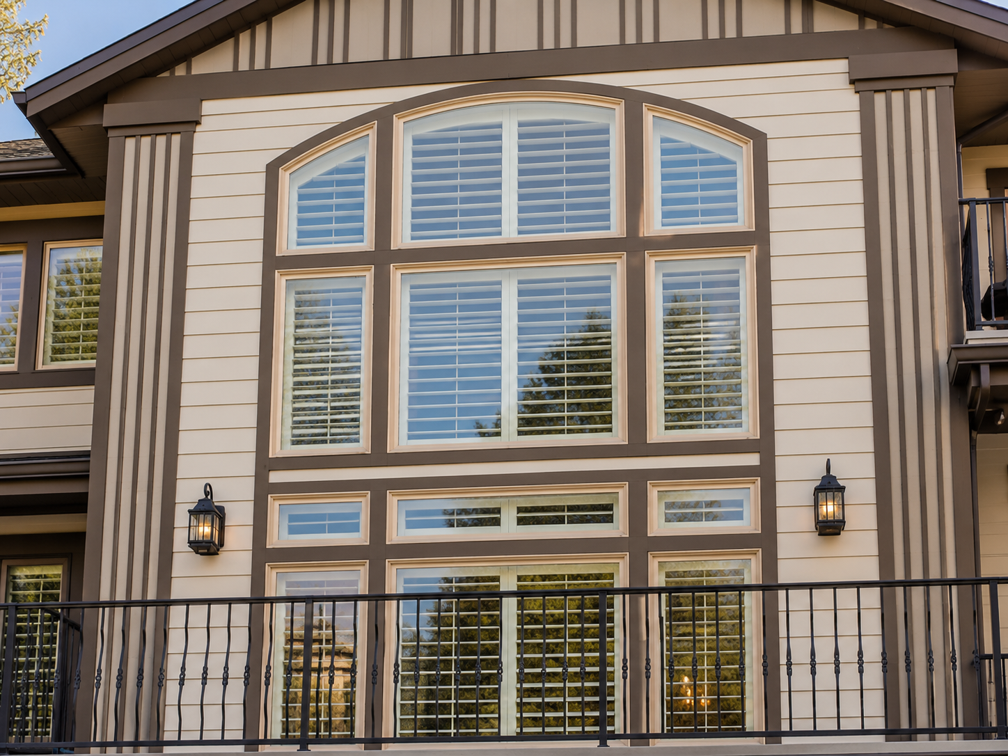 Custom plantation shutters installed across dramatic two-story windows